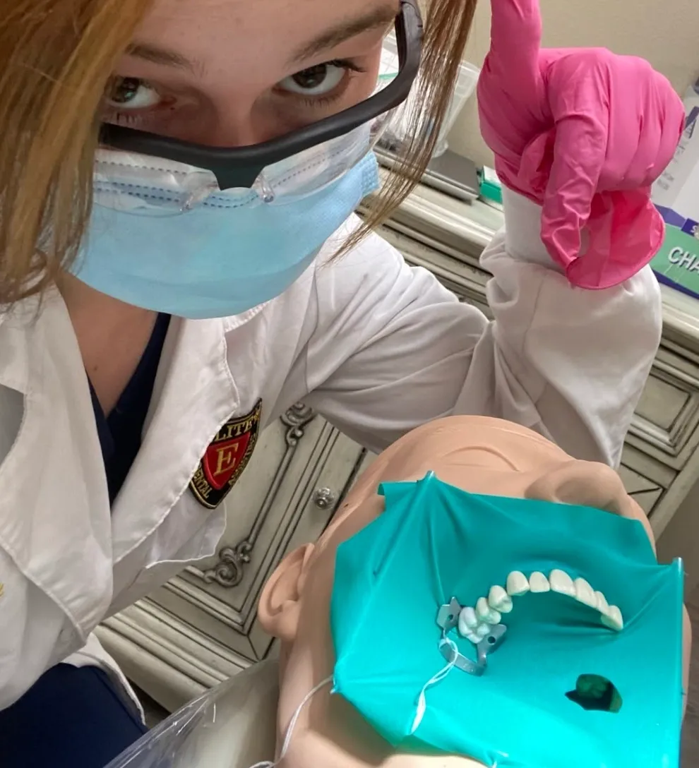 Dental student practicing on a mannequin.